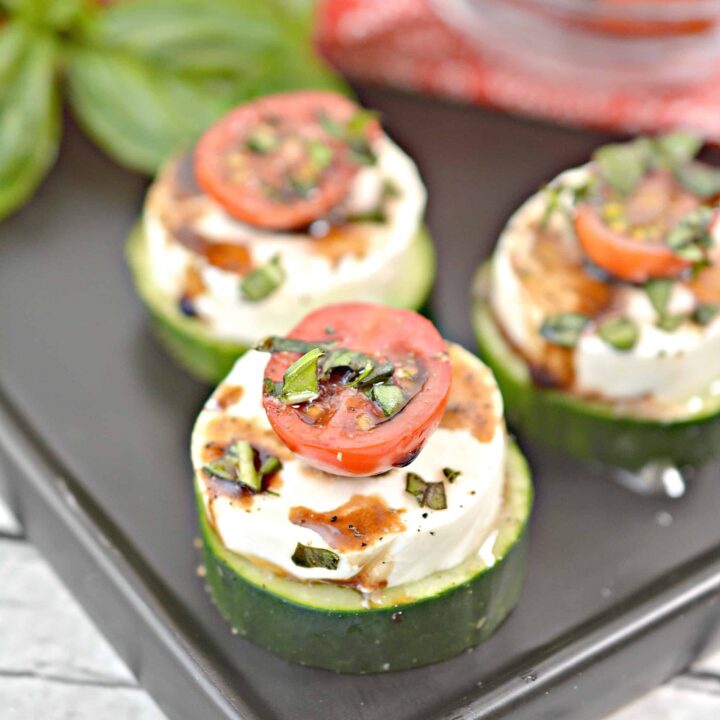 Close-up of three keto cucumber caprese appetizers.
