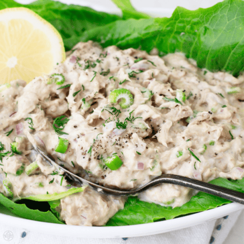 Creamy keto tuna salad served on crisp romaine lettuce with fresh dill, celery, and a lemon wedge.