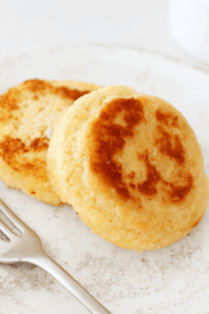 Golden slices of 90 second keto bread toasted until lightly browned, showing a fluffy interior and crisp edges, served on a plate as an easy low carb microwave bread made with almond flour.