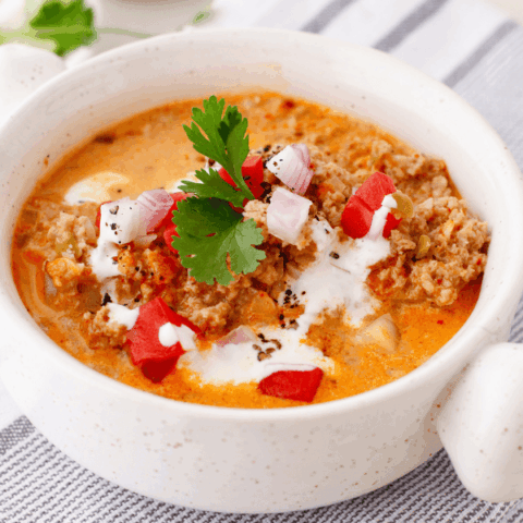 A nourishing bowl of low-carb beef soup with visible chunks of beef and vegetables in a flavorful broth.