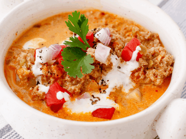 A nourishing bowl of low-carb beef soup with visible chunks of beef and vegetables in a flavorful broth.